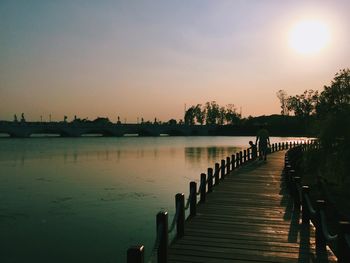 Pier on sea at sunset