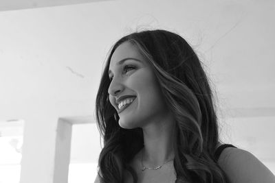 Portrait of smiling young woman looking away