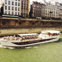 Boats in river with buildings in background