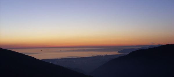 Scenic view of sea against clear sky during sunset