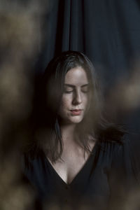 Portrait of young woman with eyes closed