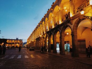 View of city lit up against sky