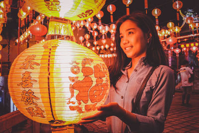 Portrait of woman with illuminated lantern
