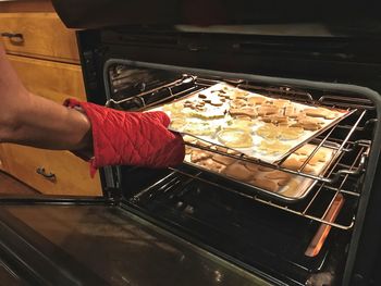 Midsection of person preparing food in kitchen