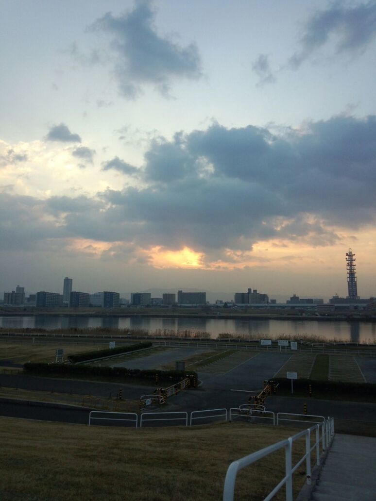 sky, cloud - sky, railing, transportation, built structure, sunset, architecture, river, bridge - man made structure, cloudy, building exterior, city, cloud, connection, road, water, outdoors, no people, nature, mode of transport