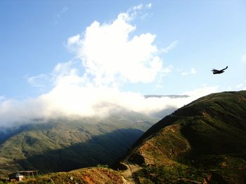 Airplane flying over mountain range
