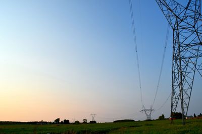 Low angle view of field against clear blue sky