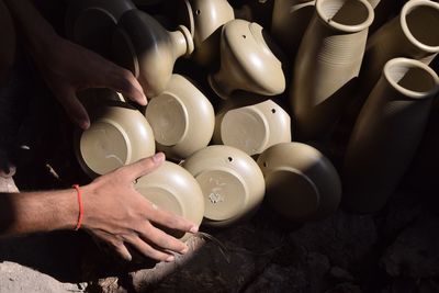 Close-up of man holding earthenware at workshop