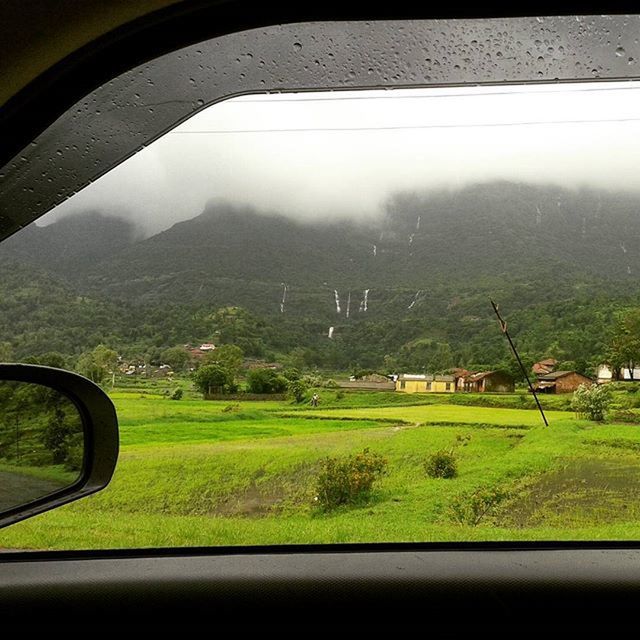 transportation, mode of transport, land vehicle, car, vehicle interior, landscape, window, field, transparent, glass - material, sky, tree, road, car interior, rural scene, side-view mirror, nature, travel, green color, grass