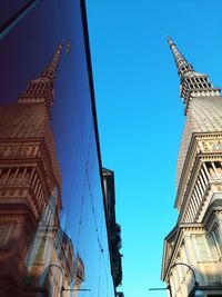 Low angle view of buildings against blue sky