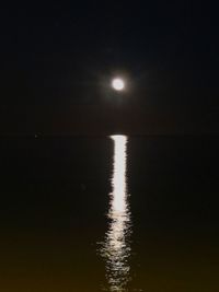 Scenic view of sea against clear sky at night