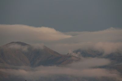 Scenic view of mountains surrounded by clouds