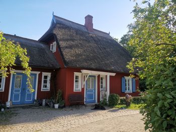 Exterior of house and trees against sky