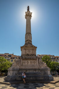 Statue of historical building against blue sky