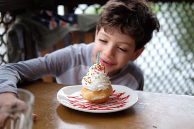 Cute boy with chocolate cake