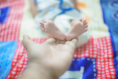 Close-up of hands on bed