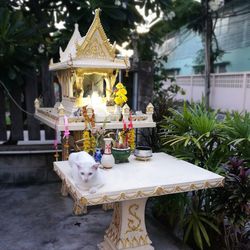 Statue on table against temple