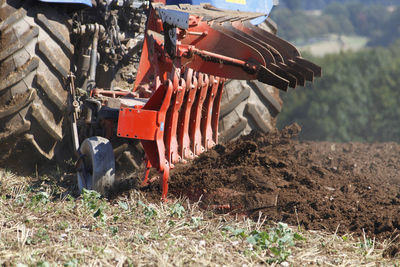 Close-up of construction machinery on field