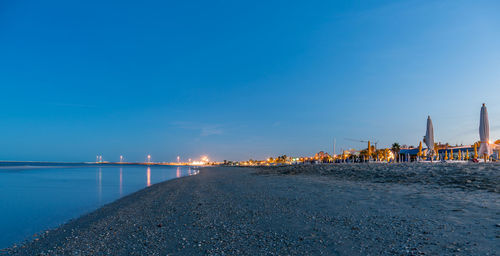 Scenic view of sea against blue sky at sunset