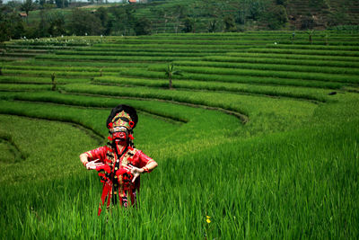 Woman wearing traditional clothes while dancing at agricultural field