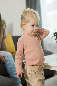 Portrait of cute girl standing at home