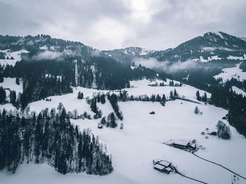 Scenic view of snow covered mountains against sky
