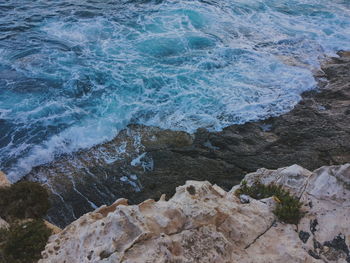 High angle view of rocks by sea