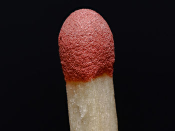 Close-up of matchstick against black background