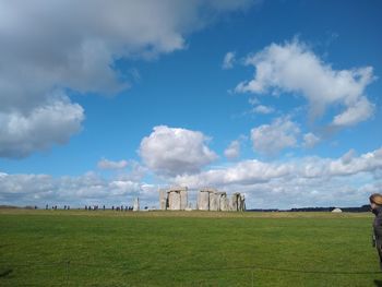 Scenic view of field against cloudy sky