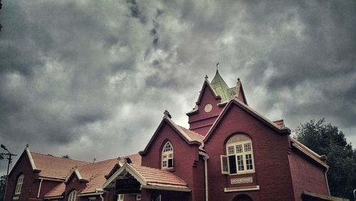 Low angle view of church against cloudy sky