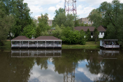 Building by lake against sky