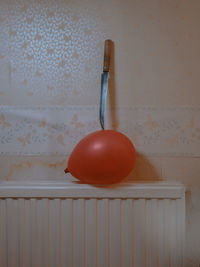 Close-up of fruit on table against wall at home