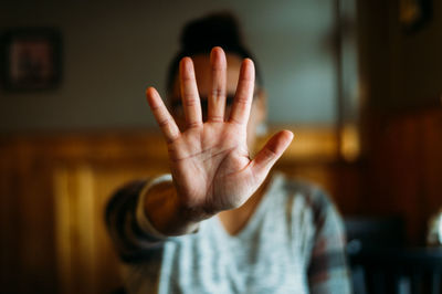 Woman holding out hand indicating stop.