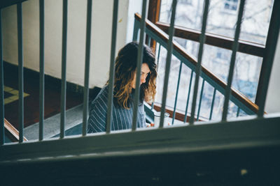 Woman looking through window