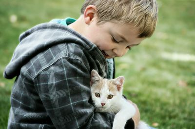 Portrait of boy holding kitten