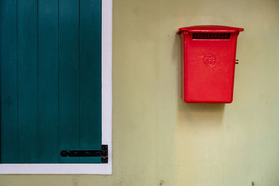 Close-up of red mailbox on wall