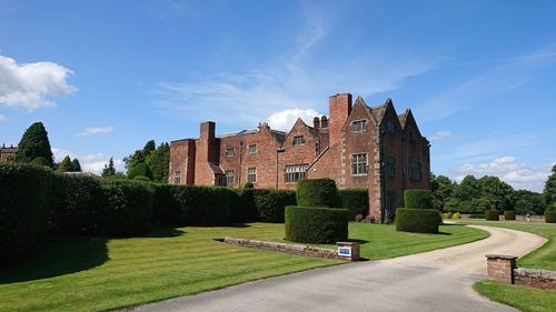 Footpath amidst buildings against sky