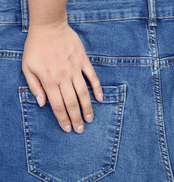 Rear view of man touching back pocket of jeans