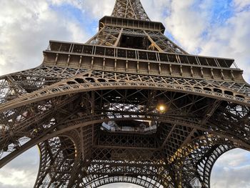 Low angle view of tower against cloudy sky