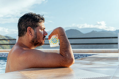 Man drinking in a pool