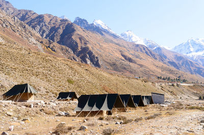 Camping area in himalayas mountain valley against clear sky 