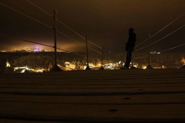 men, lifestyles, night, leisure activity, illuminated, full length, rear view, person, standing, sky, railing, walking, silhouette, outdoors, casual clothing, motion, togetherness