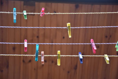 Close-up of clothespins hanging on clothesline