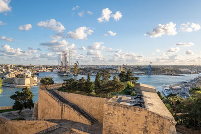 High angle view of valetta st. barbara bastion and grand harbour against sky