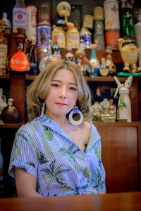 Portrait of smiling young woman standing at store