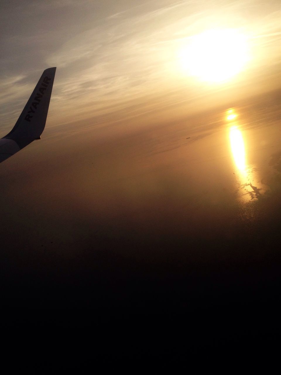 sunset, sun, airplane, aircraft wing, flying, sunlight, beauty in nature, sky, scenics, part of, nature, orange color, air vehicle, transportation, sea, tranquil scene, tranquility, aerial view, cropped, mode of transport