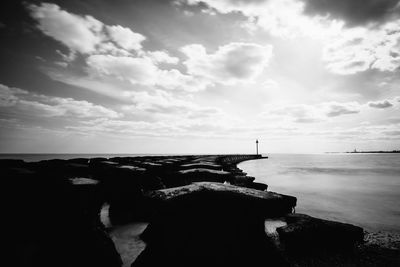 Scenic view of sea against cloudy sky