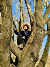 Portrait of man with tree trunk