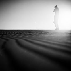 Full length of woman standing on beach