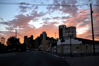 Empty road with buildings in background